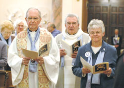 Father Bernard Head, left, former chaplain of the Sisters of Providence, processes into the Church of the Immaculate Conception with Father Daniel Hopcus, chaplain of the congregation, and Providence Sister Denise Wilkinson, general superior, on Oct. 22 for the celebration of Foundation Day and the canonization of St. Theodora Gu&eacute;rin.