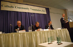 Jeffrey Stumpf, right, archdiocesan chief financial officer, speaks at the Catholic Community Foundation&rsquo;s annual meeting in Indianapolis on Oct. 25. Seated are, from left, Toby McClamroch, a member of St. Luke Parish in Indianapolis and president of the CCF&rsquo;s board of trustees, Archbishop Daniel M. Buechlein and Joseph Therber, executive director of the archdiocesan Secretariat for Stewardship and Development.