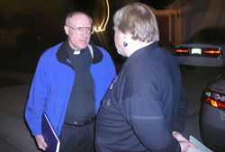 Law enforcement chaplains respond to police calls at all times of the day and night. Father Steve Schwab, the Catholic chaplain for the Marion County Sheriff&rsquo;s Department, discusses a suicide case with William Arnold, a Marion County deputy coroner.