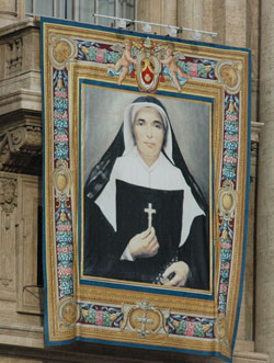 A banner of St. Theodora Gu&eacute;rin hangs from the facade at St. Peter&rsquo;s Basilica on Oct. 15 for the liturgy during which Pope Benedict XVI declared her Indiana&rsquo;s first saint. (Photo by Sean Gallagher) 