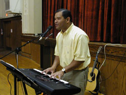 Catholic musician Tony Avellana sings during a youth rally on Respect Life Sunday on Oct. 5, 2003. He plays the piano, synthesizer, guitar and violin, and has sold 6,000 copies of his &ldquo;Journey Songs&rdquo; CD. (File photo by Mary Ann Wyand) 