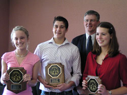 Three students from Cathedral High School in Indianapolis, from left, Katie Zupancic, Michael O&rsquo;Neil and Elizabeth Jamison, pose with their principal, Dave Worland, during a 2005 luncheon at the Knights of Columbus Hall at 511 E. Thompson Road in Indianapolis. The students were winners in their grade division in the 2005 Indianapolis Serra Club Vocations Essay Contest. (File photo by Sean Gallagher)