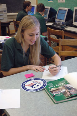 Shawe Memorial High School senior Alyssa Richard works on a yearbook page layout on Jan. 11 about the Madison school&rsquo;s designation as a national Blue Ribbon School of Excellence.