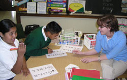 Fourth-grader Regina Casas and fifth-grader Arturo Aguilar receive tutoring in English during teacher Laura Mull&rsquo;s English as a New Language class in May 2006 at St. Philip Neri School in Indianapolis. (File photo by Mike Krokos) 