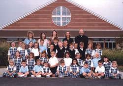 It&rsquo;s not every school that can capture all its students and teachers in one up-close photograph. Yet that&rsquo;s what happened when SS. Francis and Clare of Assisi School in Greenwood opened on Aug. 14, 2006. Shown in the top row, from left, instructional assistant Theresa Winter, first-grade teacher Angela Rykowski, kindergarten teacher Mindy Dant, Principal Sandi Patel and Father Vincent Lampert, the pastor of the parish, form the leadership of the newest school in the archdiocese. (Submitted photo) 