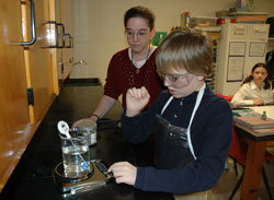 St. Rose of Lima sixth-grader William Roush of Franklin works with science teacher Amber Hayes on a chemistry experiment with new laboratory equipment. Carolyn Kurek said the dedication of the science laboratory was &ldquo;a very emotional realization that what Joe [Kurek] stood for in his life was something that was going to live on.&rdquo;