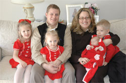 St. Simon the Apostle parishioners Chris and Paje Felts of Indianapolis pose for a family portrait on Feb. 10 with their 5-year-old twins, Madeline, left, and Patrick, right, their 2-year-old daughter, Jacqueline, and 10-week-old daughter, Anne Therese, who is named for St. Theodora Gu&eacute;rin.