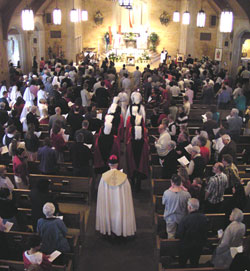 Msgr. Joseph F. Schaedel, archdiocesan vicar general, and several members of the Knights of Columbus process into St. Michael the Archangel Church in Indianapolis on April 3, 2005&mdash;the day after the death of Pope John Paul II&mdash;for the start of a Divine Mercy Sunday prayer service at the Indianapolis West Deanery parish.