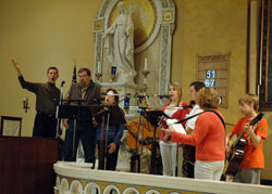 Members of St. Mary Parish in New Albany lead a congregation in singing during a Mass celebrated at the parish&rsquo;s church on Dec. 10, 2006. Liturgical musicians from across the archdiocese and around the country will gather in Indianapolis on July 9-13 for the national convention of the National Association of Pastoral Musicans. (File photo by Sean Gallagher) 