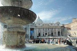 As sunlight shimmers through the falling water, a visitor to St. Peter&rsquo;s Square in Rome dips his hand into a fountain designed and built by Carlo Maderno in 1613.