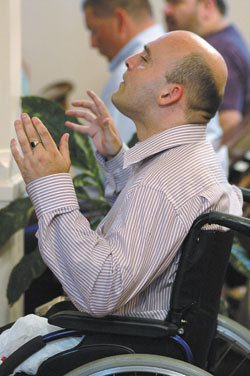 Francis McDermott, a member of St. Austin Parish in Ormskirk, Lancashire, in northwestern England, praises God and Mary in prayer as he listens to Holy Trinity parishioner Kay DeHart sing &ldquo;Ave Maria&rdquo; during Father Rick Nagel&rsquo;s first Mass of Thanksgiving on June 3 at Holy Trinity Church in Edinburgh.