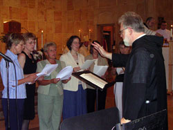 Benedictine Father Jeremy King, a monk of Saint Meinrad Archabbey, leads a multi-parish deanery choir during a June 7 Mass in honor of St. Theodora Gu&eacute;rin at St. Meinrad Church in St. Meinrad. (Photo by Patricia Cornwell) 