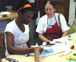Ciera Harris, who will be a seventh-grader at St.&nbsp;Lawrence School in Indianapolis, works on a puppet of a character she read about during an Art with a Heart camp held on July 11 at St.&nbsp;Philip Neri School in Indianapolis. Carol Conrad, a member of St.&nbsp;Simon the Apostle Parish in Indianapolis and founder of Art with a Heart, looks on.	