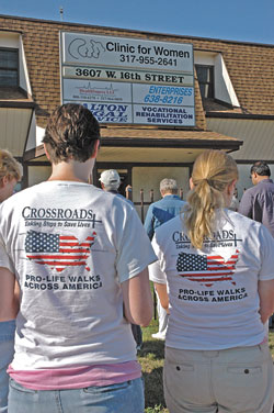 Crossroads walkers Beth Ann Flessner, left, from St. Francis of Assisi Parish in Madison, Miss., and Alzbeta Voboril from St. Francis of Assisi Parish in Wichita, Kan., pray with the archdiocesan Helpers of God&rsquo;s Precious Infants on July 21 in front of an abortion clinic in Indianapolis.	