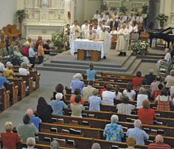 Above, members of parishes in the Seymour Deanery kneel in prayer during an Aug. 28 Mass in honor of St. Theodora Guérin for the Seymour Deanery at Prince of Peace Church in Madison.
