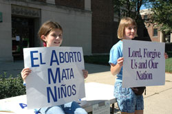 St. Joan of Arc parishioners Abby Schneider, left, and Patty Yeadon of Indianapolis participate in the Central Indiana Life Chain on Oct. 1, 2006, on North Meridian Street in front of the Archbishop Edward T. O&rsquo;Meara Catholic Center. Yeadon volunteers as a pro-life sidewalk counselor outside abortion clinics throughout the year. Life Chains are scheduled on Respect Life Sunday on Oct. 7 throughout the state. (File photo by Mary Ann Wyand) 