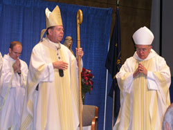 Archbishop Daniel M. Buechlein offers the closing prayer at Mass during the Indiana Catholic Men&rsquo;s Conference on Sept. 22. To his right is Denver Archbishop Charles J. Chaput, who was the homilist for the Mass.