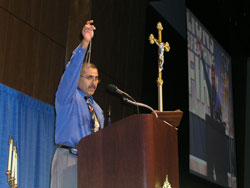 Lay evangelist Jesse Romero holds up a rosary during his presentation at &ldquo;Lions Breathing Fire: Living the Catholic Faith.&rdquo; The second annual Indiana Catholic Men&rsquo;s Conference, sponsored by the Marian Center in Indianapolis, attracted more than 1,000 men from throughout the state on Sept. 22.