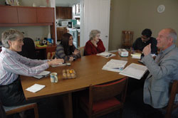 Rita Bohman, left, administrator of religious education (ARE) at St. John the Evangelist Parish in Enochsburg, speaks with archdiocesan director of catechesis Kenneth Ogorek, right, during a meeting on Nov. 16 at the Batesville Deanery parish&rsquo;s rectory. Also attending the meeting were, from left, Stacey Weisenbach, ARE at St. Maurice Parish in St. Maurice, Bertha Patterson, ARE at St. Anne Parish in Hamburg, and Father George Joseph Nangachiveettil, administrator of the three parishes.