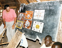 Comboni Father Michael Barton teaches Sudanese children about the Catholic faith at a Comboni primary school in southern Sudan in this file photo published on Oct. 18, 2002. He grew up in St.&nbsp;Therese of the Infant Jesus (Little Flower) Parish in Indianapolis. A new Internet blog publicizes his missionary work in East Africa. (Submitted photo) 