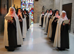 Discalced Carmelite Sisters Susanna Choi, left, and Mary Joseph Nguyen, who are novices, lead an Advent procession of the nuns at the Monastery of St. Joseph in Terre Haute in December. (Submitted photos/Carmel of Terre Haute)