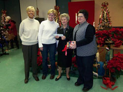 Franciscan Sister Shirley Gerth, third from left, parish life coordinator of St. Anne Parish in New Castle and St. Rose Parish in Knightstown, accepts a check for $16,488 for the St. Anne Building Fund on Jan. 6, the feast of the Epiphany of the Lord, from St.&nbsp;Anne parishioner Doris Addington-Brooks of New Castle, left, and St. Michael parishioners Connie Smith, second from left, and Lori Mayfield, right, of Greenfield. St. Michael Parish gave half of the proceeds from their annual fundraiser on Nov. 3 to help rebuild St. Anne Church, which was destroyed last year in an arson fire on Holy Saturday, April 7. (Submitted photo) 