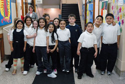 St. Philip Neri School students pose for an informal class picture on their way to lunch on Jan. 10 at the Indianapolis East Deanery grade school. Campus minister Mary McCoy stands in the hallway behind them. This year, 93 percent of St. Philip Neri&rsquo;s students are Hispanic. Five years ago, that figure was about 70 percent. English as a New Language programs and bilingual teachers are helping tino&nbsp;students and their families acclimate to a new language and culture. (Photo by Mary Ann Wyand) 