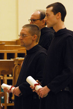 From left, Benedictine Brothers Francis Wagner and Karl Cothern hold their vow charts as they profess temporary vows as monks of Saint Meinrad Archabbey on Jan. 20 at the monastery&rsquo;s church in St. Meinrad. (Submitted photo) 