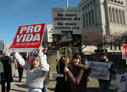 Teenagers carry pro-life signs during the Right to Life of Indianapolis Memorial Walk on Jan. 27 in downtown Indianapolis. The memorial prayer service and walk commemorated the lives of more than 48&nbsp;million unborn babies killed in abortions in the U.S. since 1973. (Photo by Mary Ann Wyand)	