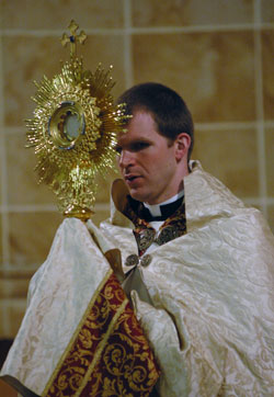 Father Jonathan Meyer carries the Blessed Sacrament in the monstrance in a procession during Benediction on Feb. 20 at Our Lady of the Most&nbsp;Holy Rosary Church in Indianapolis as part of a Lenten &ldquo;40&nbsp;Hours Devotion.&rdquo; He is the associate pastor of St.&nbsp;Luke the Evangelist Parish in Indianapolis and director of youth ministry for the archdiocese. (Photo by Mary Ann Wyand) 