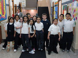 St. Philip Neri School students pose for an informal class picture on their way to lunch on Jan. 10 at the Indianapolis East Deanery grade school. Campus minister Mary McCoy stands in the hallway behind them. This year, 93 percent of St. Philip Neri&rsquo;s students are Hispanic. Five years ago, that figure was about 25 percent. English as a New Language programs and bilingual teachers are helping Latino students and their families acclimate to a new language and culture. (Photo by Mary Ann Wyand)	