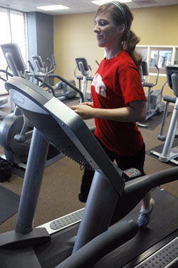 Julie Burns, a member of St. Joan of Arc Parish in Indianapolis, runs on a treadmill at her apartment complex in Indianapolis while training for the One&nbsp;America 500 Festival Mini-Marathon scheduled on May 3. She will be a member of the archdiocese&rsquo;s &ldquo;Run for Vocations&rdquo; team. (Photo by Sean Gallagher) 
