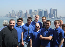 Father Robert Robeson, left, rector of the Bishop Simon Brut&eacute; College Seminary in Indianapolis, stands with seminarians on the Staten Island Ferry during their trip to New York to attend the Mass on April 20 at Yankee Stadium with Pope Benedict XVI. The seminarians are, from left, Martin Rodriguez, Gregory Lorenz, Timothy Wyciskalla, Adam Ahern, Andrew Proctor, Benjamin Syberg and Daniel Bedel. All except Ahern are archdiocesan seminarians. Ahern is affiliated with the Archdiocese of Cincinnati. (Submitted photo) 