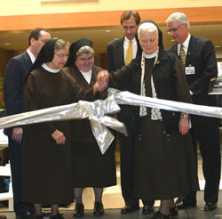Several St. Francis Hospital officials cut a ribbon on April 16 to officially open the expanded St. Francis Hospital-Mooresville in Mooresville. They are, from left, Keith Jewell, chief operating officer of St.&nbsp;Francis Hospital and Health Centers; Franciscan Sisters of Perpetual Adoration Jane Marie Klein, chairperson of the Sisters of St. Francis Health Services Inc. board of trustees, and Angela Mellady, her order&rsquo;s provincial superior; Dr. John Meding, medical staff president of St. Francis Hospital-Mooresville; Franciscan Sister of Perpetual Adoration Mediatrix Nies, the order&rsquo;s general superior; and Robert Brody, president and chief executive officer of St. Francis Hospital and Health Centers in Beech&nbsp;Grove, Indianapolis and Mooresville. (Submitted photo ) 