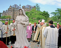 Archbishop Pietro Sambi, apostolic nuncio to the United States, blesses a statue of St.&nbsp;Theodora Gu&eacute;rin, Indiana&rsquo;s first saint, on May 10 in Mary&rsquo;s Garden outside the Basilica of the National&nbsp;Shrine of the Immaculate Conception in Washington. Members of the Sisters of Providence of Saint&nbsp;Mary-of-the-Woods, the religious community founded by St. Theodora in 1840, stand behind the statue. (Submitted photo/Sisters of Providence)