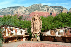 Red rock formations are a stunning backdrop for the Shrine of Our&nbsp;Lady of Guadalupe&mdash;Nuestra Senora de Guadalupe&mdash;in the Sedona Gardens of St. John Vianney in Arizona, a popular destination for Catholic tourists visiting the Southwest. While enjoying the gardens, visitors can attend Mass at the church. Father&nbsp;J. C. Ortiz, the pastor, is the author of a book of meditations illustrated with color pictures of the beautiful gardens. (Submitted photo courtesy Al Brown)