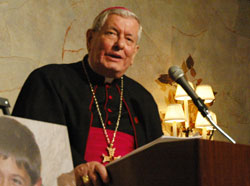 Archbishop Pietro Sambi, apostolic nuncio to the United&nbsp;States, speaks on May&nbsp;3 at the Meridian Hills Country Club in Indianapolis during a fundraising dinner sponsored by the Franciscan Foundation for the Holy Land. The dinner supported the Franciscan Boys Home in Bethlehem. Photos of the home&rsquo;s residents are displayed next to Archbishop Sambi. (Photo by Sean Gallagher)