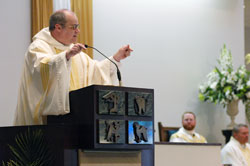 Benedictine Father Denis Robinson, the new president-rector of Saint Meinrad School of Theology in St.&nbsp;Meinrad, preaches a homily on June 8 at the Mass of Thanksgiving of newly ordained Father Joseph Newton at Our Lady of the Greenwood Church in Greenwood. In the background are, from left, Father Newton and Msgr. Mark Svarczkopf, pastor of Our Lady of the Greenwood Parish. (Photo by Sean Gallagher)