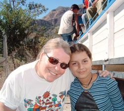 Alice Mattingly, left, and Blanqui, a resident of Portillo, El&nbsp;Salvador, smile for the camera during one of Mattingly&rsquo;s mission trips to Portillo. A third-grade teacher at St. Pius X School in Indianapolis, Mattingly has made about 15 trips to the remote village in the El Salvadoran mountains and helped get her North Deanery parish and school involved in outreach efforts to the Central American country. (Submitted photo) 