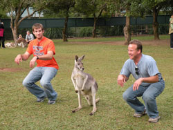 Two archdiocesan World Youth Day pilgrims do the &ldquo;kangaroo hop&rdquo; with a resident of the Australia Zoo near Beerhwah on July 12. (Photo by Katie Berger) 
