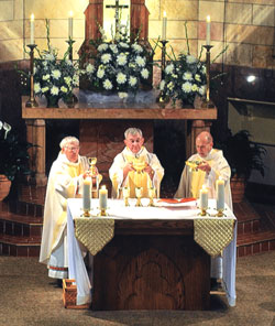 Marking his 50th year as a priest, Father Harold Ripperger, center, concelebrates Mass with his brother, Father William Ripperger, left, and Msgr. Harold Knueven, right. The anniversary Mass was celebrated on May 17 at St. Mary Church in Lanesville. Father&nbsp;Harold Ripperger is the pastor of St. Mary Parish in Lanesville. (Submitted photo) 
