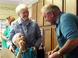 Providence Sister Susan Dinnin shares a moment of joy with Thelma and Tom Weinzapfel at A Caring Place Adult Day Services, a program of Catholic&nbsp;Charities Indianapolis. Sister Susan has been the site manager at A Caring Place since it opened in 1990. Thelma comes to the program three&nbsp;days a week, which offers Tom an opportunity to take time for himself. The Weinzapfels are members of St. Christopher Parish in Indianapolis. (Photo by John Shaughnessy) 