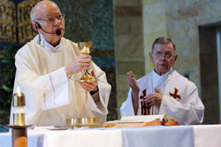 Father Herman Lutz, left, celebrates Mass with Father Henry Brown in the chapel at St. Paul Hermitage in Beech Grove on May&nbsp;11, 2006. He serves as the chaplain at the Hermitage and lives in the priests&rsquo; wing of the retirement home operated by the Sisters of St. Benedict of Our Lady of Grace Monastery. (File photo by Sean Gallagher) 