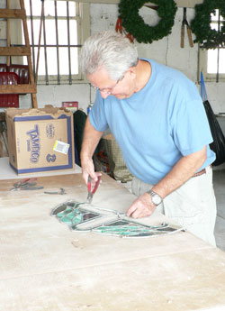 St. Anne parishioner David Johnson of New Castle creates a stained-glass design from pieces of the former church windows. The historic Henry County church was gutted in an arson fire on Holy Saturday in 2007. (Submitted photo)