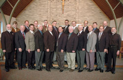 Posing for a class picture on Aug. 23 in the chapel of Our Lady of Fatima Retreat House in Indianapolis are, front row, from left, Benedictine Father Bede Cisco, deacon aspirants Frank Roberts, Rick Renzi, Rick Cooper, Mark Meyers, Ron Pirau, Joe Geiman, Mike Slinger, Rick Wagner, Jeff Powell and Father&nbsp;Lawrence Voelker. In the back row are from left, Deacon Kerry Blandford and deacon aspirants Tom Hill, Mike Braun, Jim Miller, Brad Anderson, Tom Harte, Steven House, Russ Woodard, Tom Horn and Ron Freyer. (Photo by Sean Gallagher) 