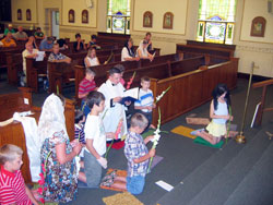 Father Shaun Whittington, pastor of St. John the Baptist Parish in Osgood, prays on July 16 in adoration of the Blessed Sacrament with children during a children&rsquo;s holy hour. The prayer service is&nbsp;part of the Apostolate for Family Consecration&rsquo;s &ldquo;Consecration in Truth&rdquo; catechetical program. (Photo by Jennifer Lindberg) 