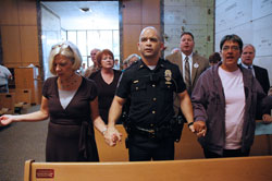 Indianapolis Metropolitan Police Department Lt. Vincent Cascella, center, prays the Lord&rsquo;s Prayer with other participants during the sixth annual archdiocesan Blue&nbsp;Mass that paid tribute to public servants on Sept. 11 at the Calvary Cemetery Mausoleum Chapel in Indianapolis. He is a member of St. Roch Parish in Indianapolis, and represented the IMPD&rsquo;s Southeast District at the liturgy. (Photo by Mary Ann Wyand) 