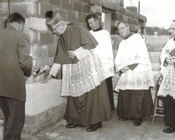 In this Archive photo, Archbishop Paul C. Schulte touches the cornerstone of St.&nbsp;Matthew the Apostle Church after he blessed it during the construction of the parish&rsquo;s facilities in 1958. Priests assisting Archbishop Schulte were, from left, Father&nbsp;Albert Diezeman, St. Matthew&rsquo;s first pastor; Msgr. Henry Hermann and Father&nbsp;Cyril Conen. (Submitted photo) 