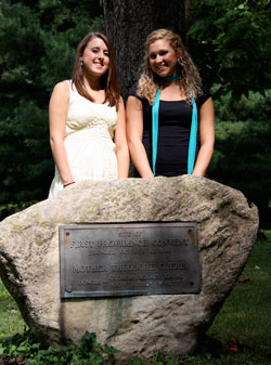 Cousins Ashley Vermillion, left, and Jena Thralls stand by a historical marker on the campus of Saint Mary-of-the-Woods College. The rock memorializes the moment in 1840 when St. Theodora Gu&eacute;rin ended a three-month journey from France and arrived in the Indiana wilderness where she was welcomed and given shelter by the ancestors of Ashley and Jena, who are both freshmen at the college. (Submitted photo by Lynn Hughes) 