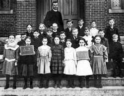 Students at St.&nbsp;Mary School in Greensburg pose outside their school building in 1910 with the parish&rsquo;s pastor, Father Lawrence Fichter. The Batesville Deanery parish is celebrating the 150th&nbsp;anniversary of its founding this year. (Submitted photo) 